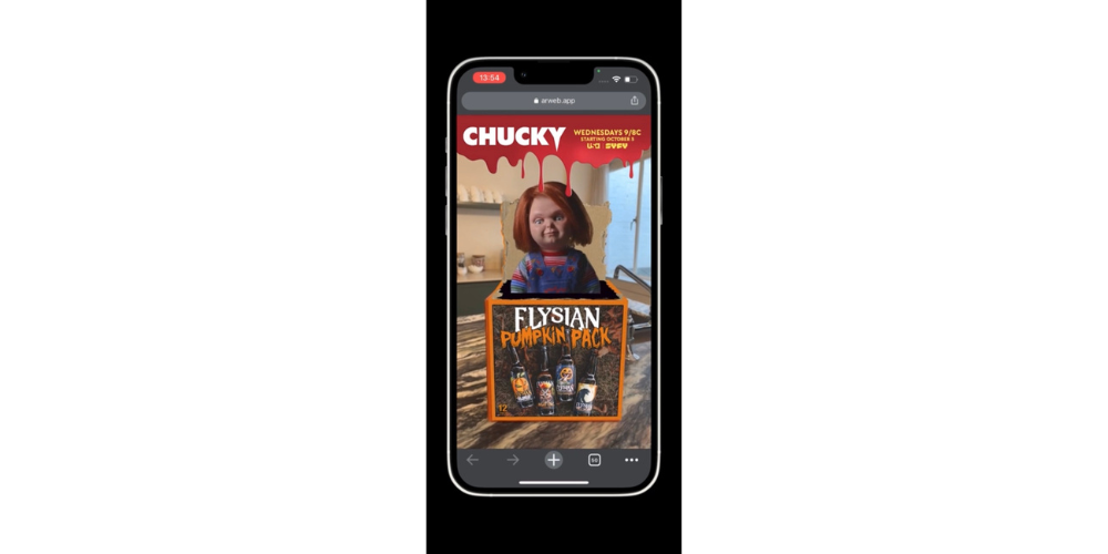 Image shows Chucky from NBC show emerging out of box on a smartphone in a world tracked AR experience built with ZapWorks. 